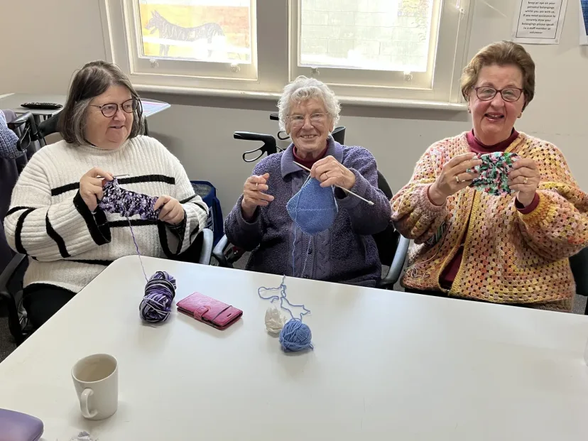 Members of a craft group knitting and crocheting together