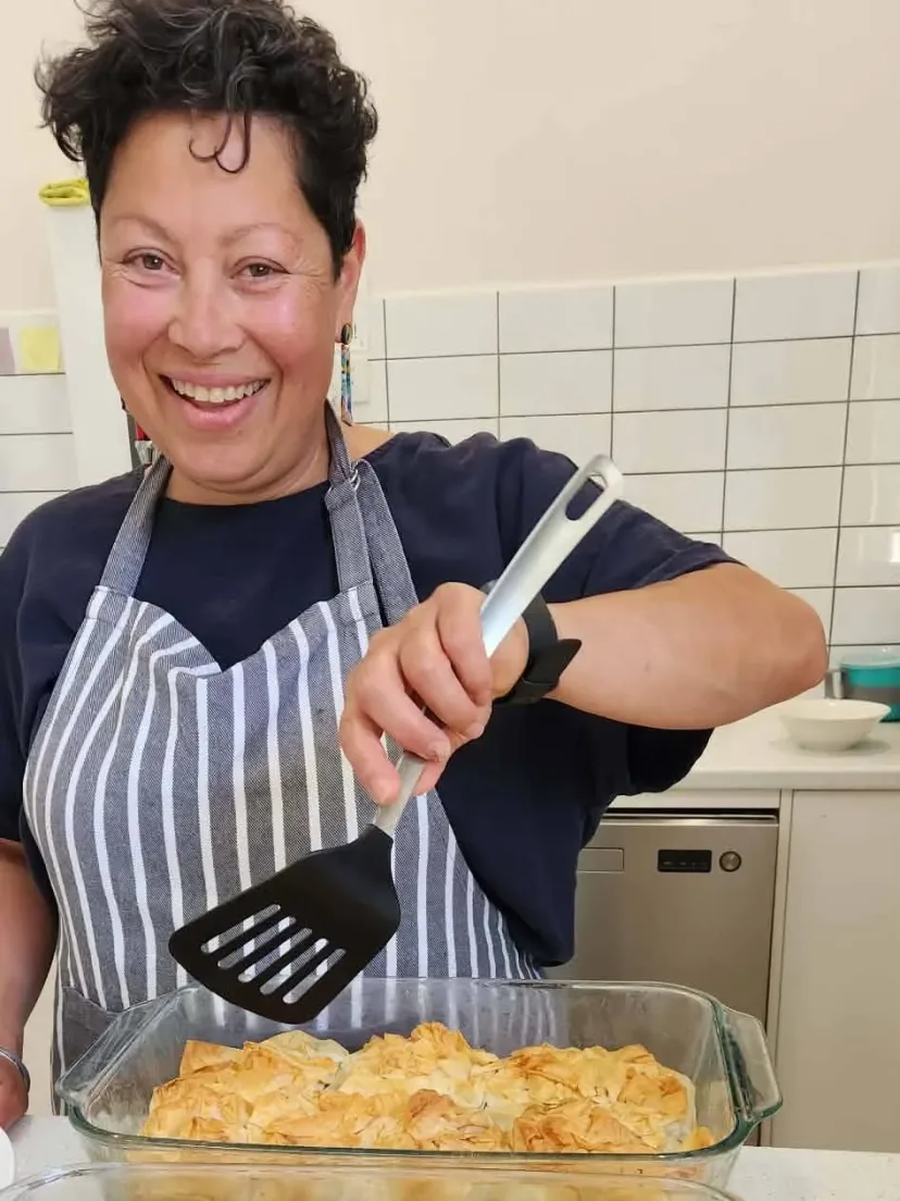 Emma, our chef, with a fresh tray of bake in the community kitchen