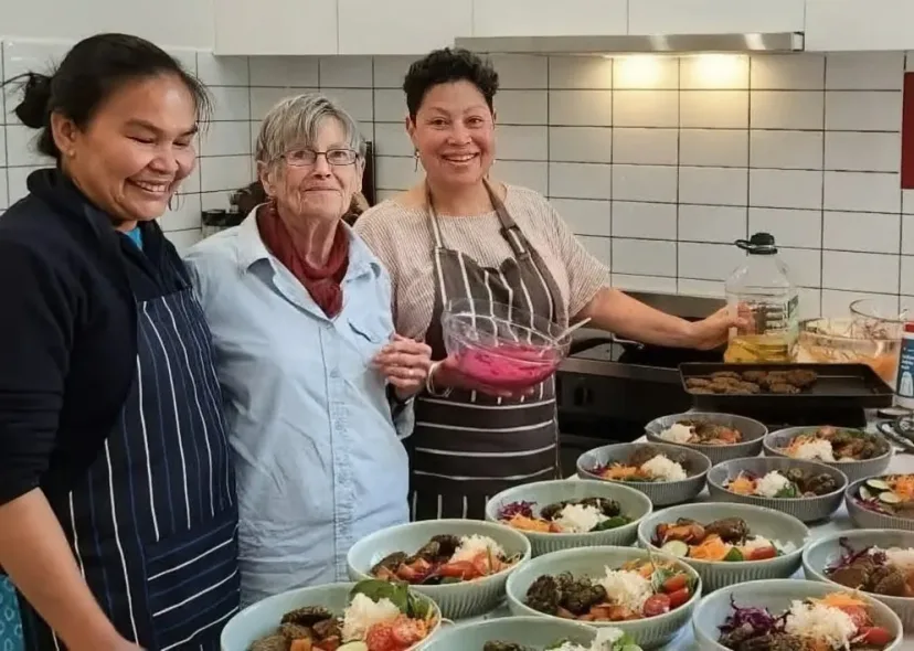 Volunteers packing fresh meals in the Mitchell House kitchen